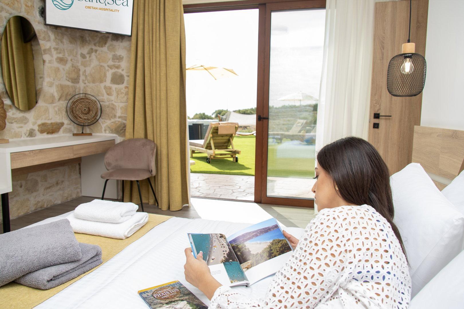 woman enjoying guide books on her bed